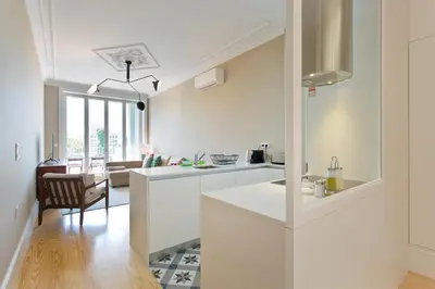 a kitchen with white counters and a dining room at Soulmade Porto in Porto