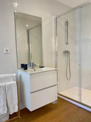 a white bathroom with a sink and a shower at Oporto Chic&Cozy - Ribeira in Porto