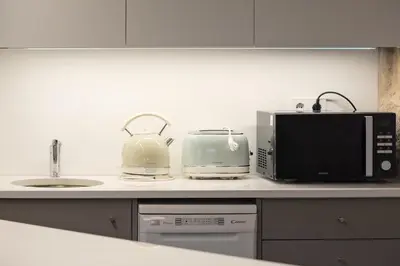 a kitchen counter with a microwave and a toaster at Oporto Chic&Cozy - Ribeira in Porto