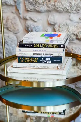 a stack of books sitting on top of a table at Oporto Chic&Cozy - Ribeira in Porto