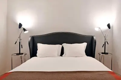 a bed with a black headboard and two lamps at Oporto Chic&Cozy - Ribeira in Porto