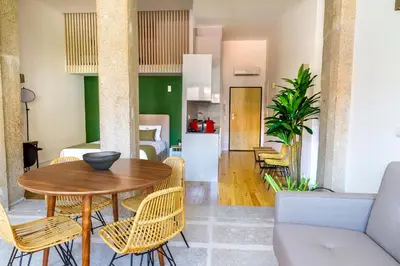 a dining room and living room with a table and chairs at Formosa 178 by Guestify in Porto