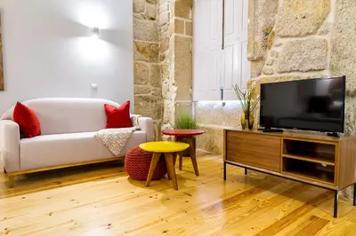 a living room with a couch and a tv at Formosa 178 by Guestify in Porto