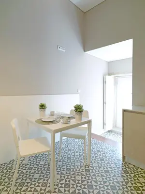 a dining room with a white table and chairs at FLH Porto Bright Flat in Porto
