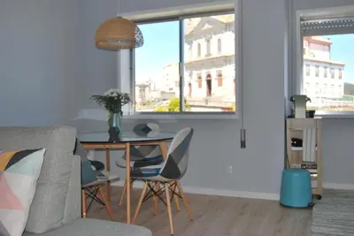 a living room with a table and chairs at Bessa Apartment in Porto