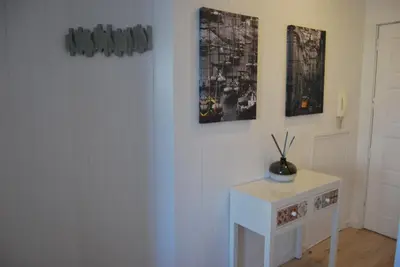 a room with a white table and some pictures on the wall at Bessa Apartment in Porto