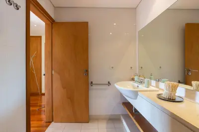 a bathroom with a sink and a mirror at Music Relaxing Apt with bikes, terrace & parking in Porto