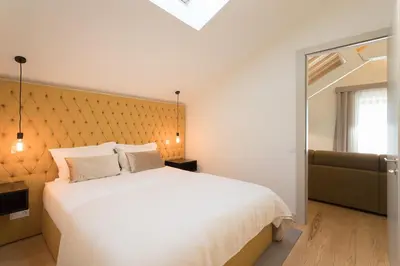a bedroom with a large white bed and a window at Santa Catarina Apartments in Porto