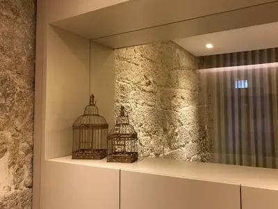 a mirror with a bird cage on a shelf at Santa Catarina Apartments in Porto