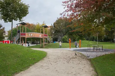 a playground in a park with people walking around at Covelo Park Apartment in Porto