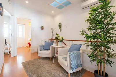 a living room with two chairs and a table at Covelo Park Apartment in Porto
