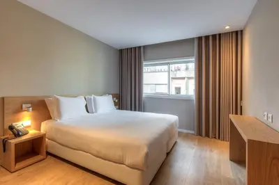 a hotel room with a bed and a window at Spot Family Apartments in Porto