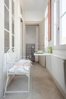 a white bathroom with a white chair in a room at Get a Unique and Luxury Flat in Porto