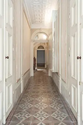 an empty hallway with a tile floor in a building at Get a Unique and Luxury Flat in Porto