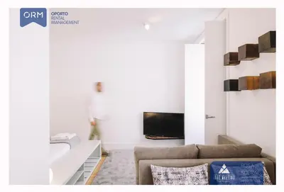 a living room with a couch and a tv at ORM - Almada Apartments in Porto
