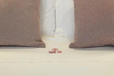 a close up of three pillows on a bed at HM - The Garden in Porto