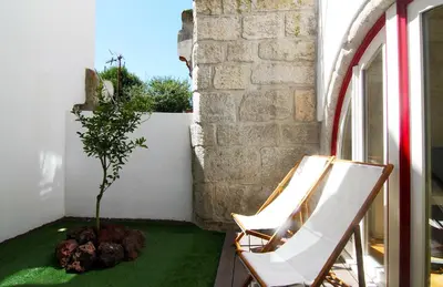 two chairs and a tree on a balcony at HM - The Garden in Porto