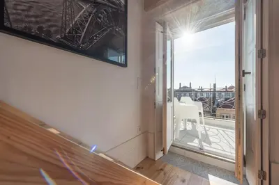 a room with a view of a balcony at Sá de Noronha Mezzanine w Terrace in Porto