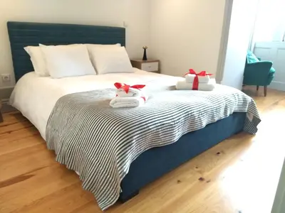 a bedroom with a bed with two stuffed animals on it at Lusitania Garden Apartment - Jardim Privado in Porto