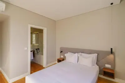 a white bed with white pillows in a bedroom at N Apartments - Bolhão in Porto
