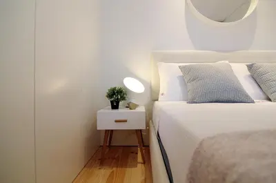 a bedroom with a bed and a table with a plant on it at HM - Pinheiro Cosy Apartment in Porto