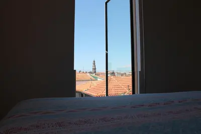 a bedroom with a bed and a large window at Amazing Penthouse Apartment in historic Porto in Porto