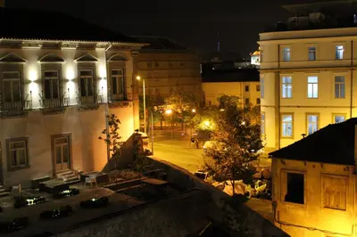 a view of a street at night with buildings at Amazing Penthouse Apartment in historic Porto in Porto