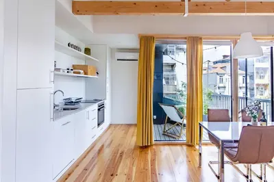 a kitchen and dining room with a table and a balcony at Amazing Penthouse Apartment in historic Porto in Porto