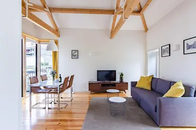 a living room with a couch and a table at Amazing Penthouse Apartment in historic Porto in Porto