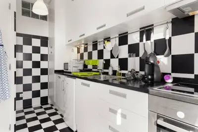 a kitchen with black and white checkered wall at Rendez Vous Porto in Porto