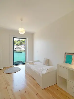 a white bedroom with a bed and a large window at FLH Luxury Porto River View in Vila Nova de Gaia