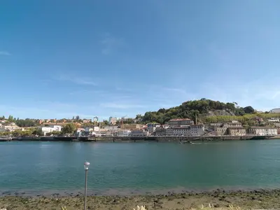 a large body of water with a town in the background at FLH Luxury Porto River View in Vila Nova de Gaia