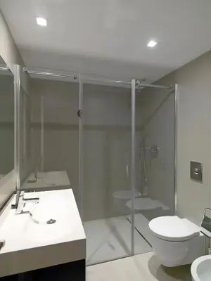 a bathroom with a glass shower and a toilet at FLH Luxury Porto River View in Vila Nova de Gaia