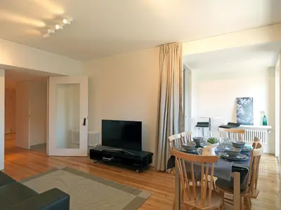 a living room with a table and a television at FLH Luxury Porto River View in Vila Nova de Gaia