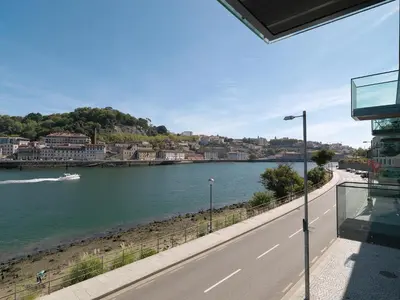 a view of a river from a balcony of a building at FLH Luxury Porto River View in Vila Nova de Gaia