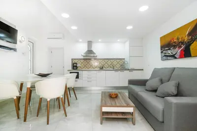 a living room with a couch and a table at Maredimo Village Porto Casa 1 in Porto