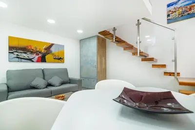 a living room with a staircase and a couch at Maredimo Village Porto Casa 1 in Porto