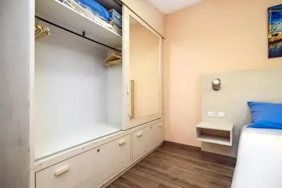 a small bedroom with a bed and a closet at Maredimo Village Porto Casa 1 in Porto
