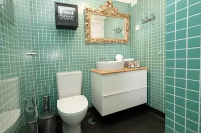 a bathroom with a toilet and a sink and a mirror at Porto Duke's House in Porto