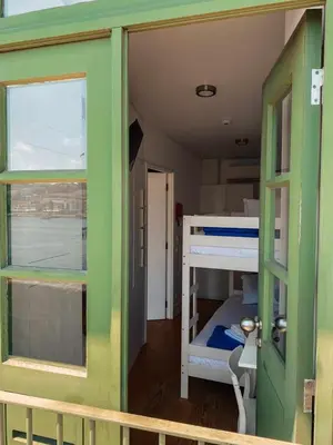a small room with a bunk bed and a window at Panorama Apartments Ribeira Porto in Porto