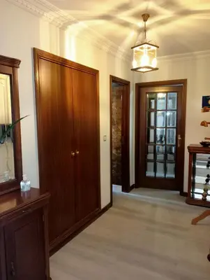 a living room with wooden doors and a chandelier at Apartamento Alvares Cabral in Vila Nova de Gaia