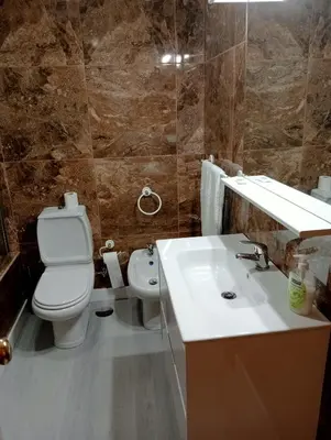 a bathroom with a white toilet and a sink at Apartamento Alvares Cabral in Vila Nova de Gaia