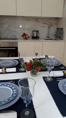 a table with blue and white plates and wine glasses at Oporto Cosy Apartment at Alegria in Porto