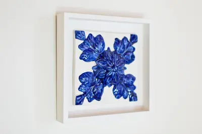 a picture of a blue flower in a white frame at Ribeira Stay Apartments in Porto