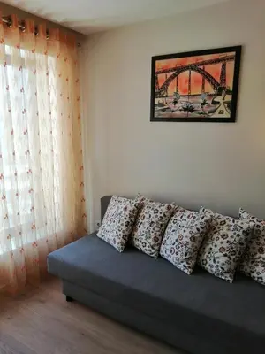 a couch with pillows on it in a room at BC Porto Downtown Apartment in Porto