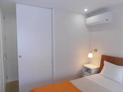 a bedroom with a bed and a sliding glass door at BC Porto Downtown Apartment in Porto