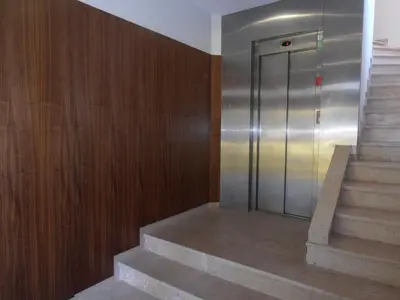 a metal elevator in a building with stairs at BC Porto Downtown Apartment in Porto