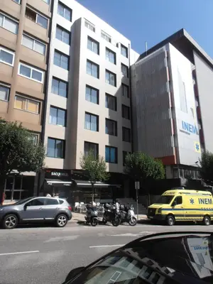 a building with cars and motorcycles on a city street at BC Porto Downtown Apartment in Porto