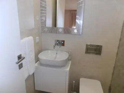 a bathroom with a sink and a toilet and a mirror at BC Porto Downtown Apartment in Porto