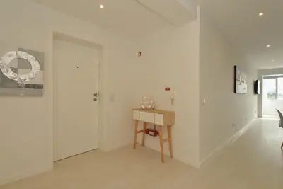 a white room with a table and a door at Downtown Prime Porto in Porto